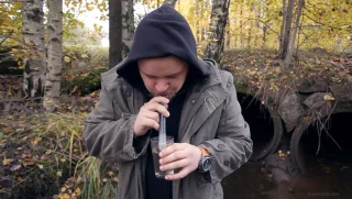 Here's Simo drinking the filty water of the Rotten River just outside our store.