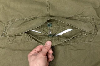The opening for the head closes with several overlapping layers. Whether it actually keeps water out is something we haven't confirmed. Fortunately you have a steel helmet!