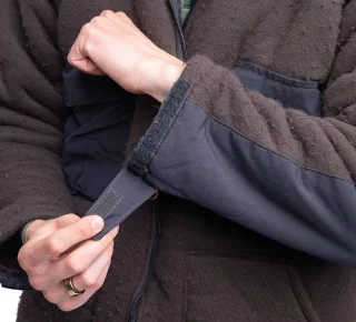 Velcro tabs at the cuffs.
