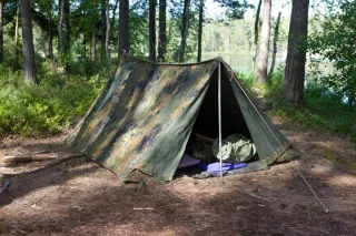 Two shelter halves can be combined to make a 2-person pup tent. Stakes, poles, guylines etc. sold separately.