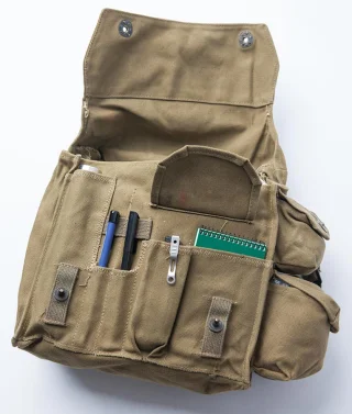 An example of contents: Särmä TST notebook (small), a multitool, couple of pens and an Ukkomatti hip flask.