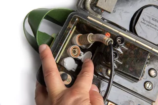 The handset can be connected to these terminals. There are no extras but how many people do you want to join your remote meeting anyway?