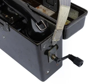 The crank can be found under the lid and it is screwed on the outside. It is used to activate and terminate the calls. 