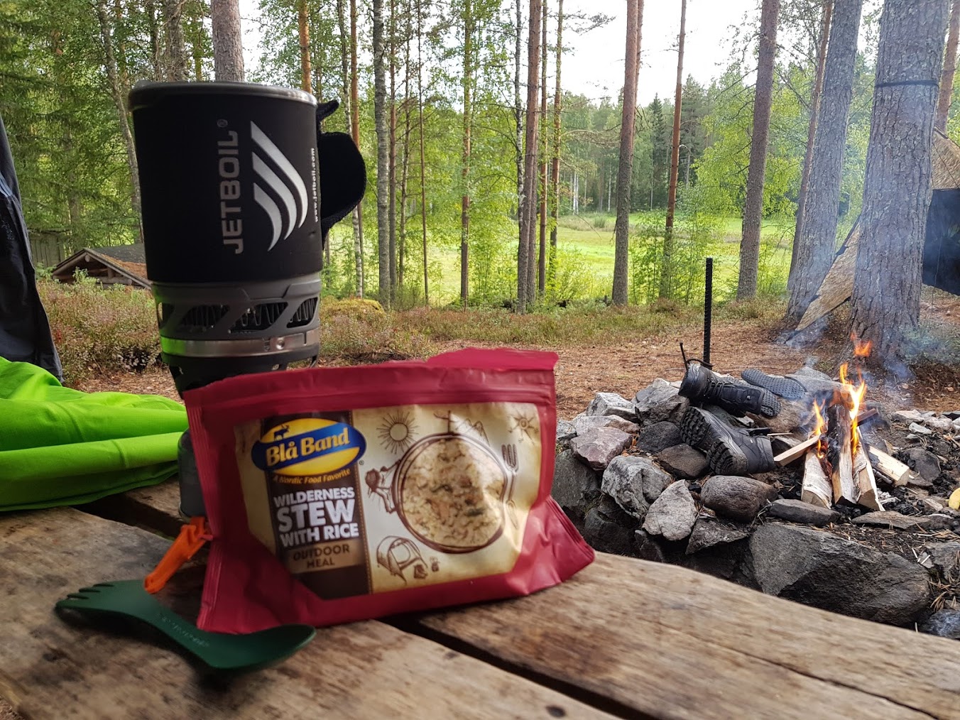 Jetboil and a bag meal next to a camp fire.