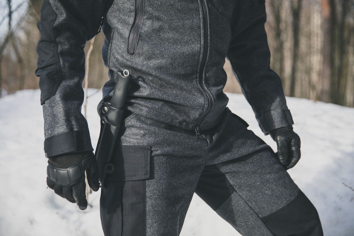 A grey wool hiking suit in winter surroundings.