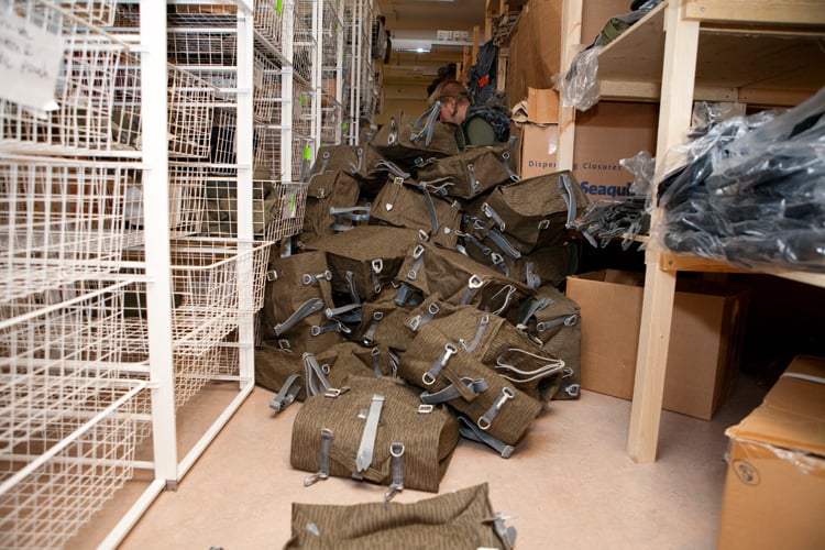 A warehouse with an isle filled with large-ish brown-ish bags.