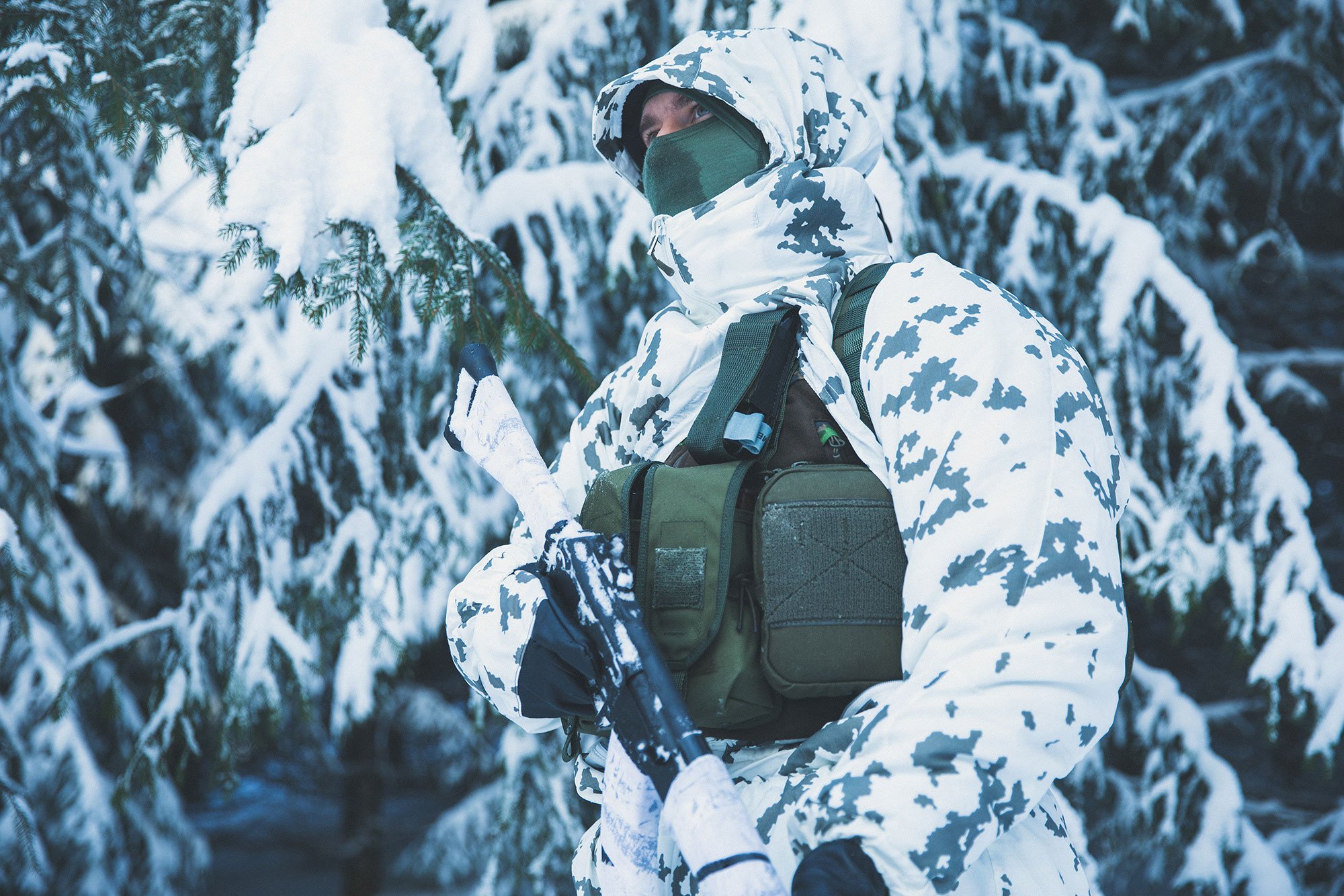 L7 snow camo soldier in spruce forest