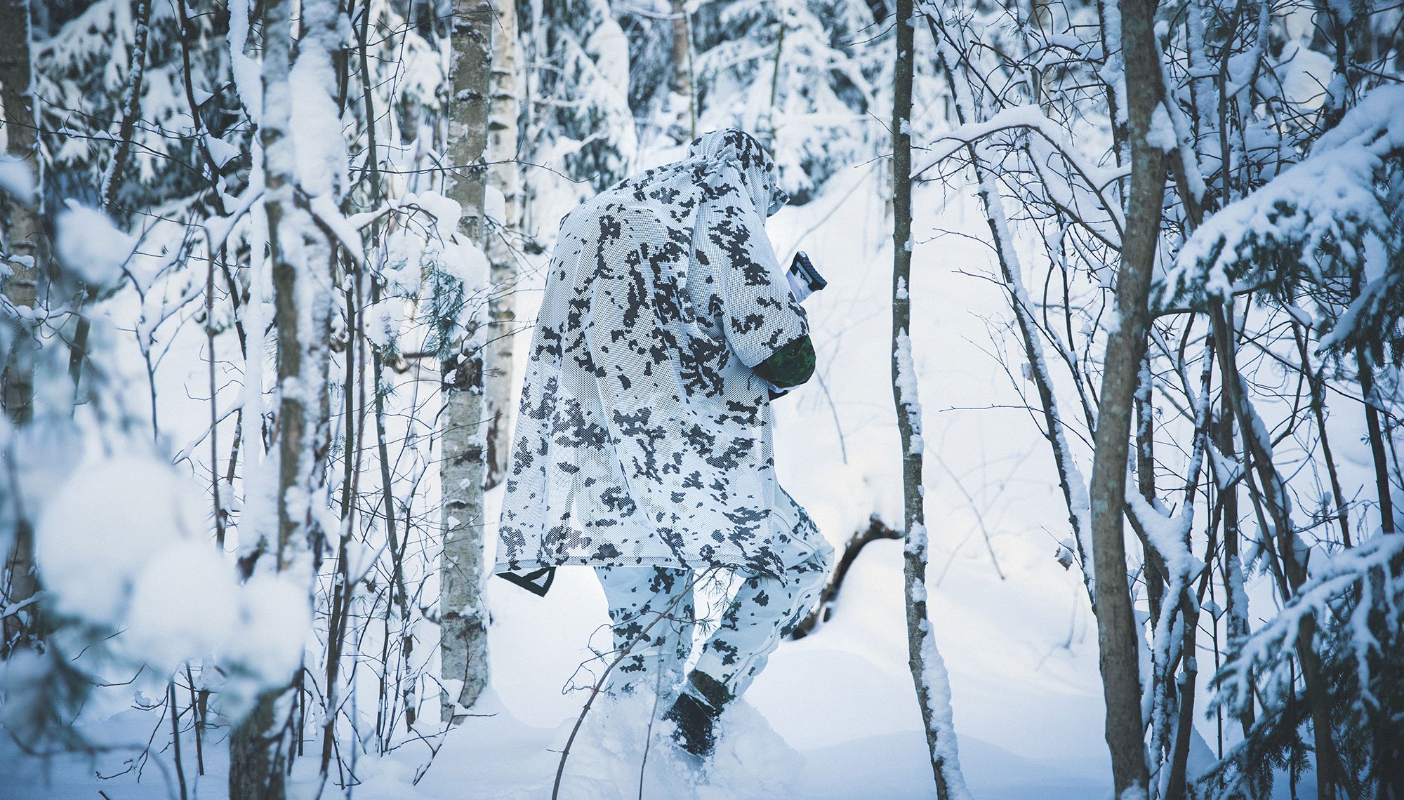 All camoulflaged soldier in the forest