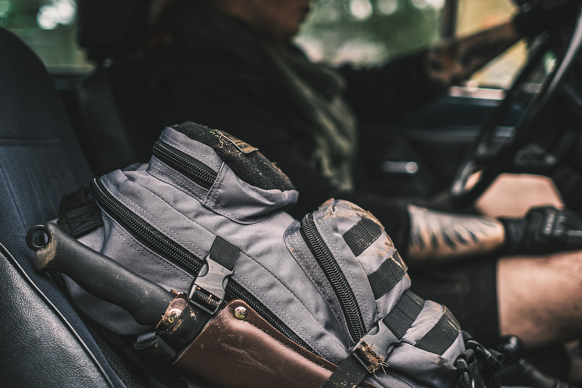 Särmä large assault backpack and Skrama on the front seat of a car