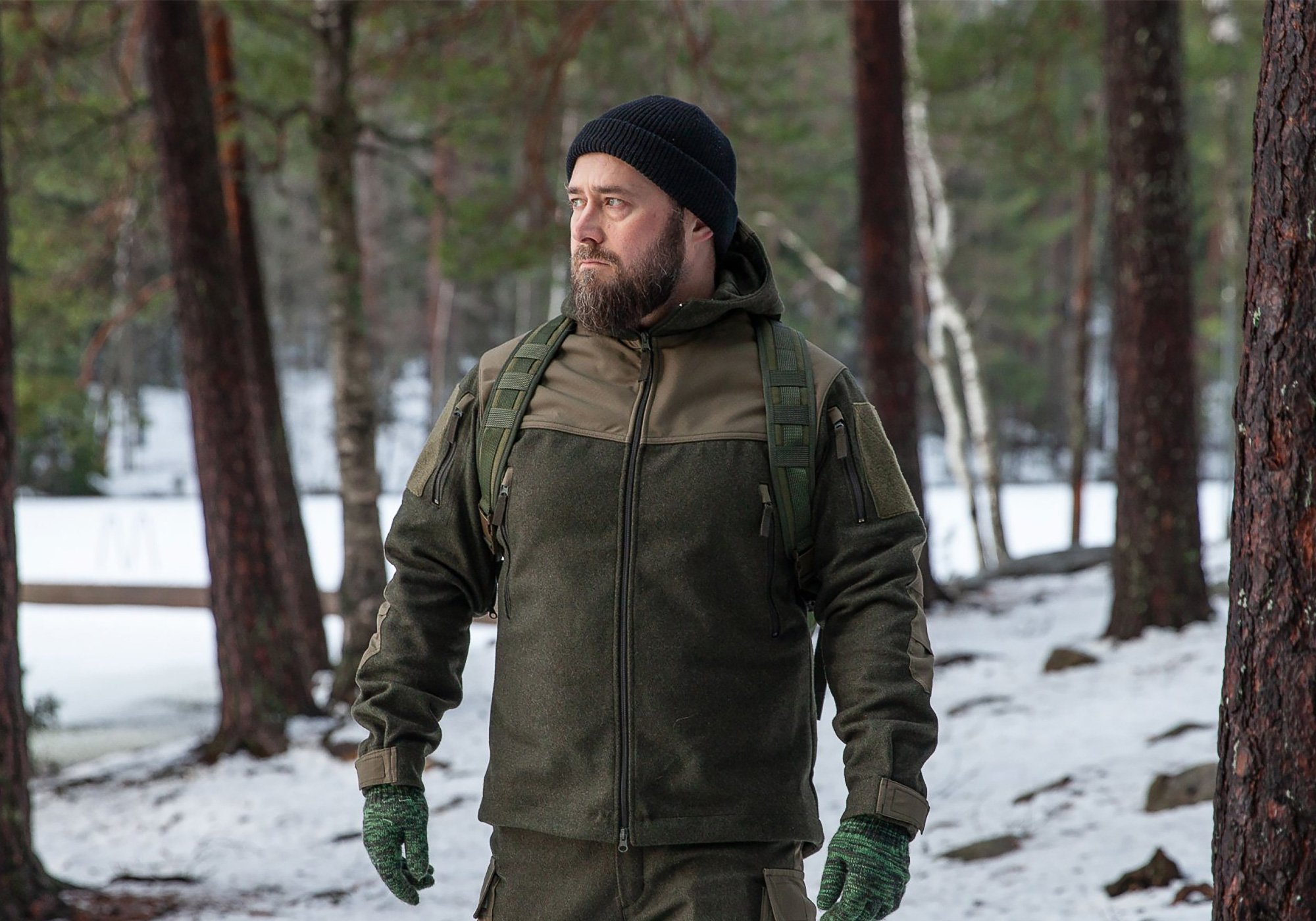 Man in the forest waring Varusteleka Särmä TST Woolshell outfit