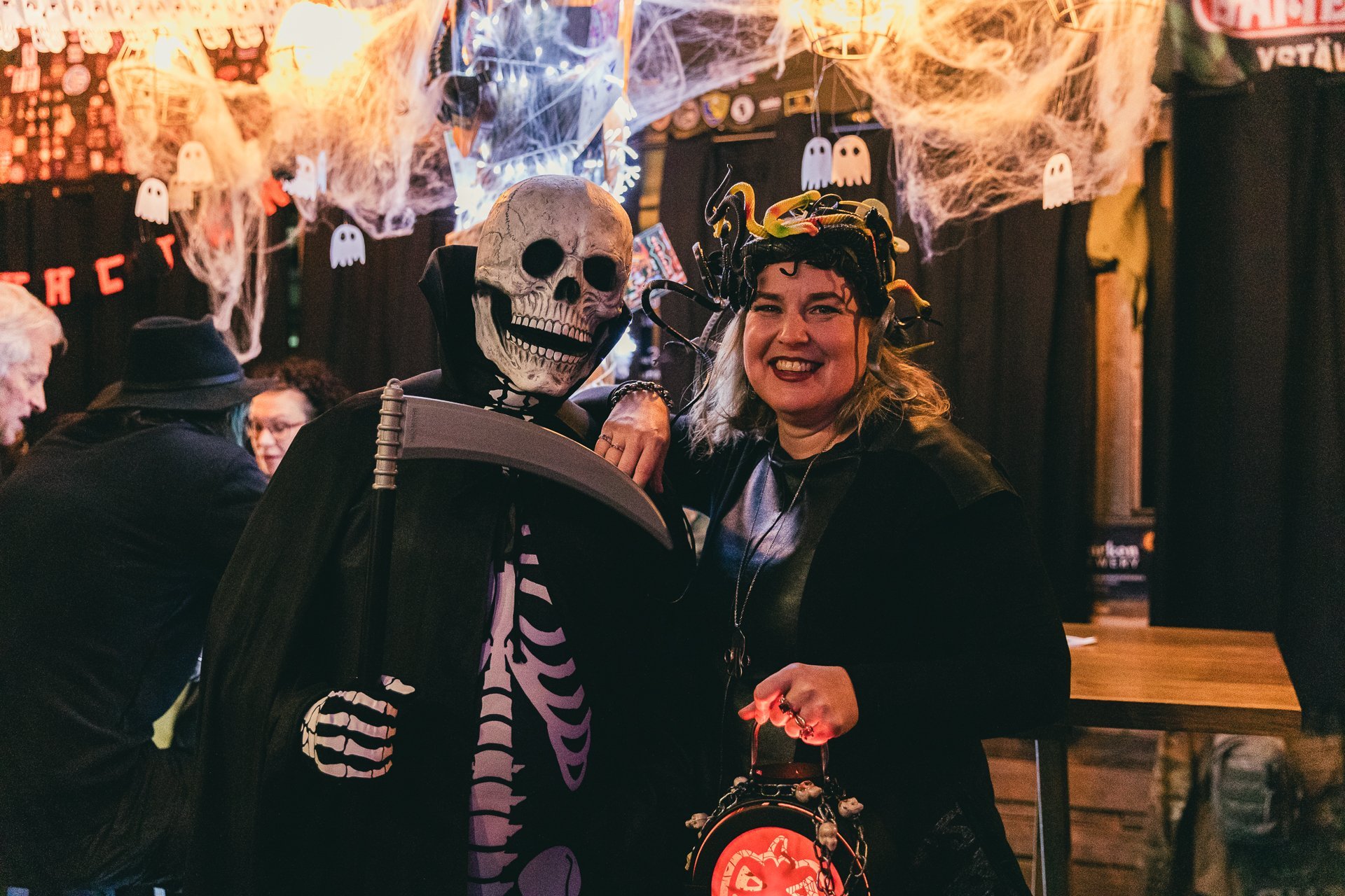 The reaper and a medusa at a Halloween costume party.