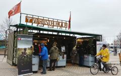 People checking out stuff at the Varusteleka container shop.