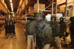 Five or six soldiers inside the warehouse.