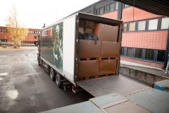 The back of the Rnakaisija VI truck which is filled with card board boxes of products from bottom to top.