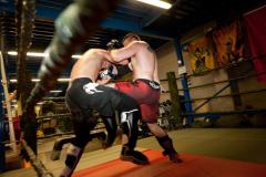 Two men fighting on the mat.