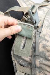 US MOLLE II Assault Pack, Surplus. Passages for antennae, cables, a hydration tube, and for extra attachment straps in airborne operations.