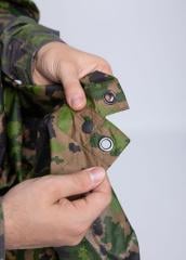 Särmä TST L6 Rain poncho, M05 woodland camo. Press studs along the sides for closing up, grommets in all corners and in the middle of all sides for tie down use.