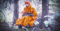 Särmä Rain Poncho. A rain poncho is a cozy place to sit in while holding a rifle.