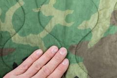 US "Woobie" Poncho Liner, Woodland, Surplus, Unissued. The stitching keeps the batting in place and the light top fabric keeps pack size small.