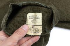 US Wool Scarf, Surplus. Several manufacturers. Most seem to be 100% wool but some newer ones might have a little bit of synthetic stuff for strength.
