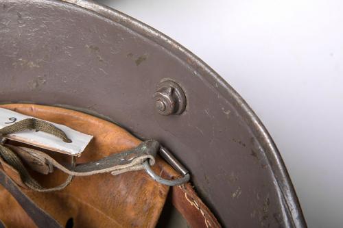 Finnish German M16 steel helmet, surplus. Old and new chin strap attachment point.