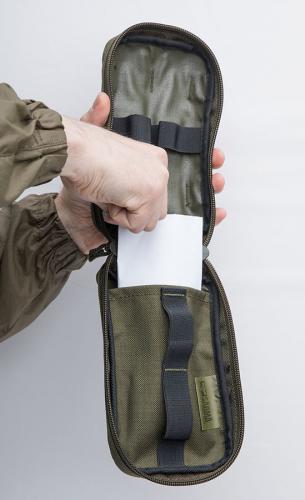 Särmä TST IFAK pouch. A piece of paper highlights the opening of the flat compartment.