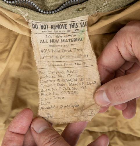 US M-1942 Sleeping Bag #1. The owner of this bag abided by the law - that's good! It's not often you see a sleeping bag filled with duck down and feathers.