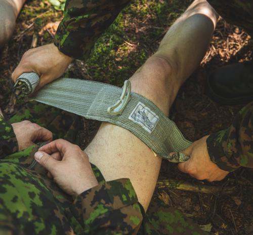 Hunter's first aid kit. Emergency bandage in action. Less blood than you would have in a live situation. We also didn't want to cut off the pants this time.