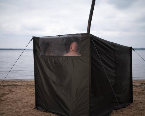 Savotta Hiisi 2 Two-Person Sauna Tent. Window behind the bench for peeking (outside) and to let light in.