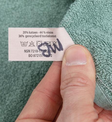 Dutch Terry Towel, Green, Surplus. The wash tags have magical markings.